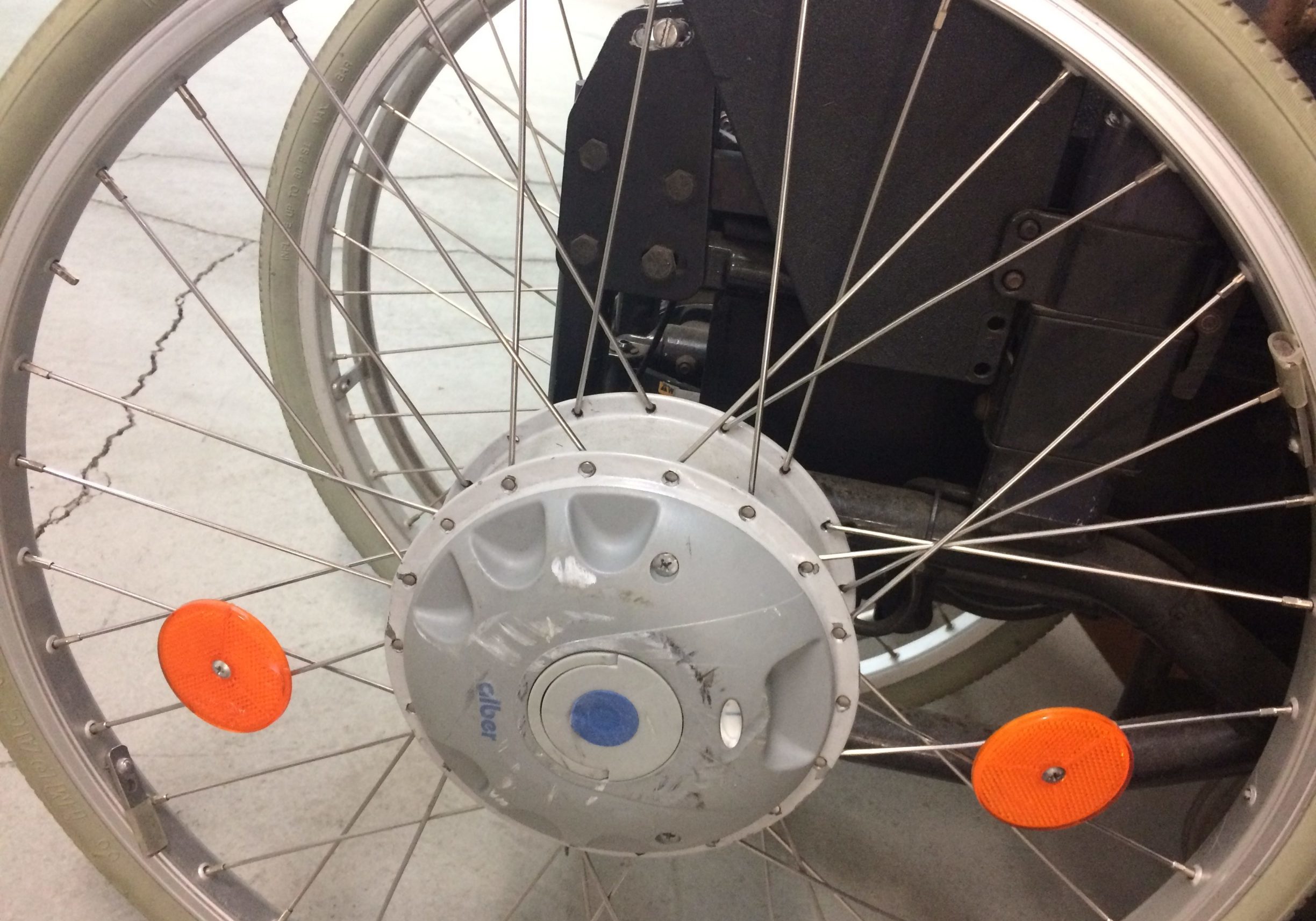 A bicycle wheel with orange discs on it